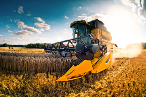 a machine drives over a wheat field